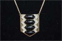 18ct onyx & diamond pendant on gold chain,