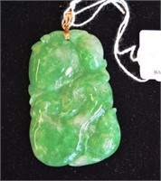 Carved green jade pendant with 18ct gold