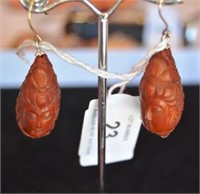 Pair of carved wooden earrings each in the form of