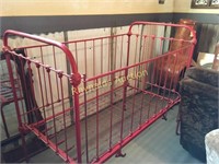 red vintage iron baby bed