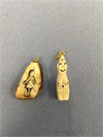 Pair of ivory pendants - one is a bilikin and the