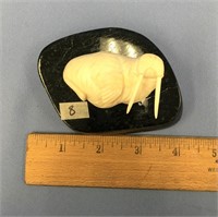 3" white ivory walrus mounted on a piece of soapst