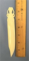 Bone letter opener with an octopus carved on it -