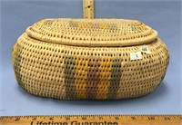 A large handmade grass basket with a lid, overall