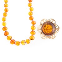 A Strand of Amber Beads and Amber Brooch