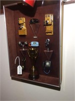 Model phones and award in shadow box