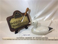 Snow goose carving and carved sign