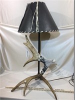 Lamp with eagle head carved from antler