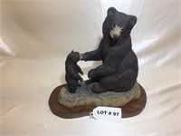 Woodcarving of mother bear and cub
