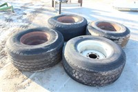 (4) TIRES ON 22.5" 8-HOLE RIMS, ASSORTED SIZES AND