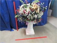 large floral arrangement in plaster stand