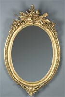Louis XVI detailed carved oval gilt mirror.