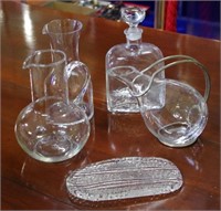 Three glass carafes and a decanter