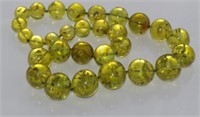 Good graduated green amber necklace