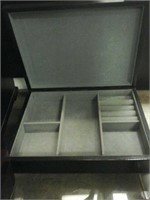 Black wooden jewelry box with grey interior and