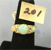 An 18K gold opal and diamond ring, has four diamon