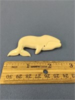 A white walrus ivory whale pin, 2 3/4" long
