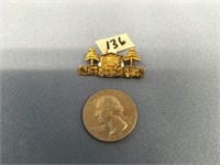 Gold nuggeted pin of a cabin in the woods, weight: