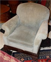 AN UPHOLSTERED CLUB CHAIR
