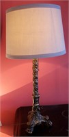 A GILDED AND GESSOED PAW FOOT TABLE LAMP