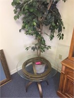 Glass-top end table and tree in corner