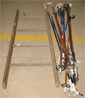 (13) Various size ski poles and a small wood