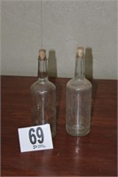 Pair of vintage bottles with wavey glass