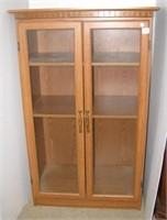 Three shelf cabinet with two glass doors.