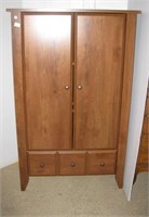 Storage cabinet with two shelves and single door.