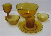 Large group of amber glass glassware including