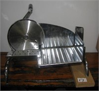 Hand cranked meat slicer.