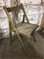 Vintage folding wooden chair with woven seat