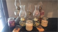 Lot of five oil lamps, three Yankee style candles
