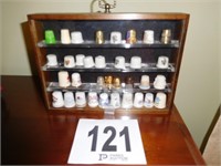 COLLECTION OF THIMBLES IN A HANGING RACK