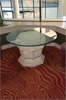 Glass topped table with cast base