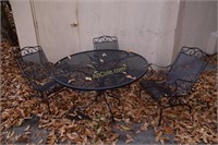 1 Outdoor round table; black, with 3 chairs.