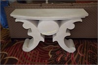 Heavy cast table. Top rests on base; approx56" x