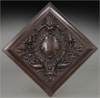 Carved wood wall plaque featuring a central