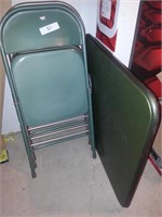 Three metal folding chairs and card table