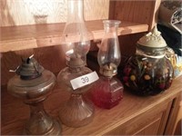 Three oil lamps tow with hurricanes and one large