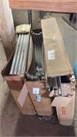 Three boxes of table legs, chrome