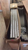 Three boxes of table legs, chrome