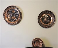 Three metal wall plaques