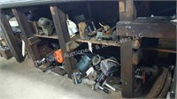 Steel, parts & electric motors under workbench