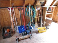 Lot of tools, compressor, and metal roller in shed