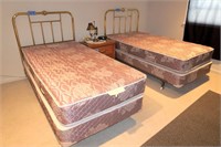Two Twin beds with brass headboards;