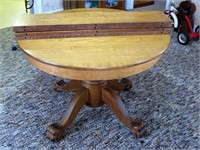 42" Round oak pedestal table with claw feet