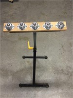 adjustable height material roller