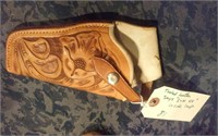 Tooled leather holster, has S&W 44 inside loop