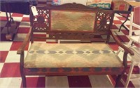 Carved wooden love seat w southwestern upholstery